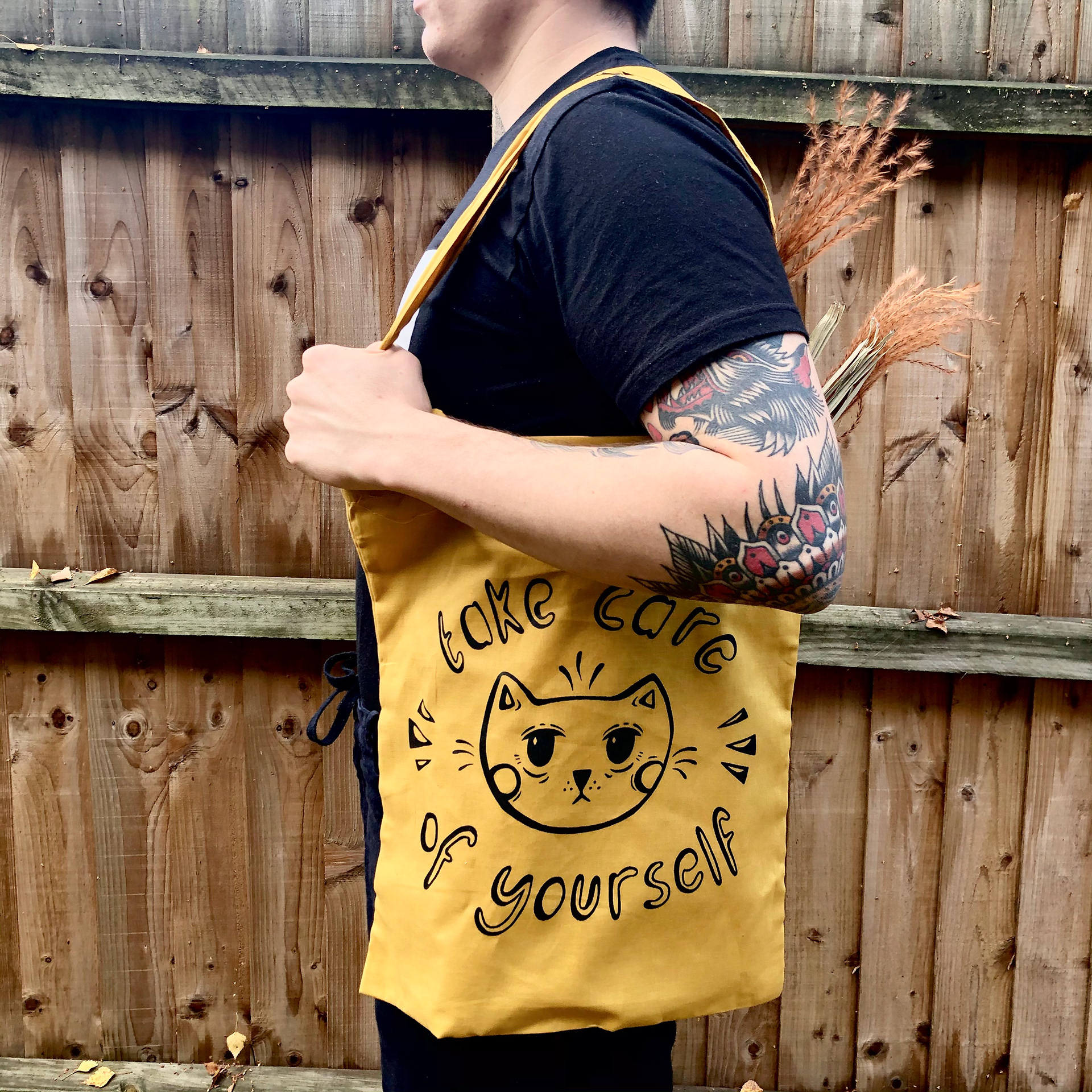 Take Care Tote Bag. Black ink screen-printed on mustard.