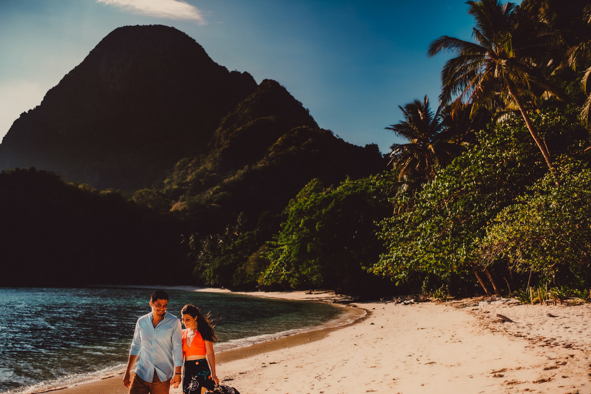 A couple walking on an empty beach in Cadlao Island, from Peter &amp; Alexis' adventure engagement shoot in El Nido, Palawan, Philippines, Southeast Asia, April 2018, Sony A7SII