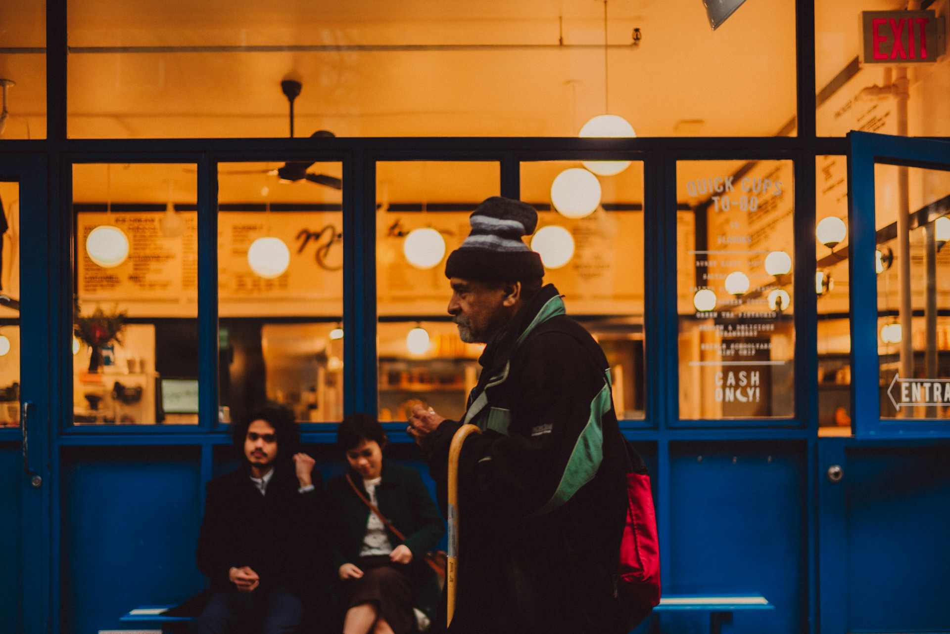 Street photography-style couple portraits outside Morgenstern's Finest Ice Cream, from AC &amp; Winona's casual and chill engagement shoot in Manhattan, New York City, USA, December 2017, Leica M.