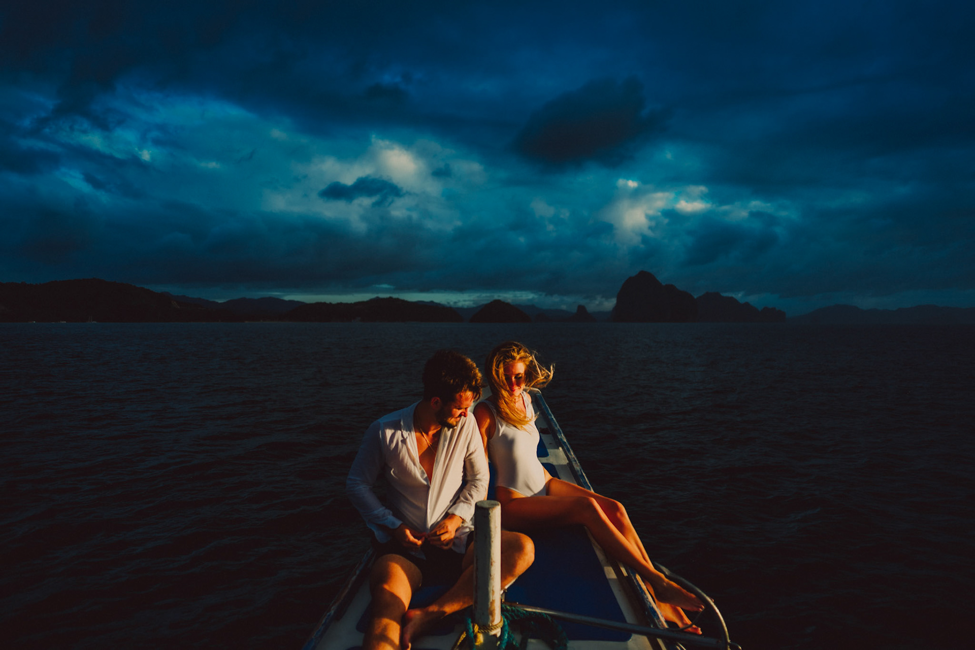 Moody golden hour island hopping adventure couple portraits against a gloomy sky, El Nido, Palawan, Philippines, Southeast Asia, December 2019, Sony A7III.
