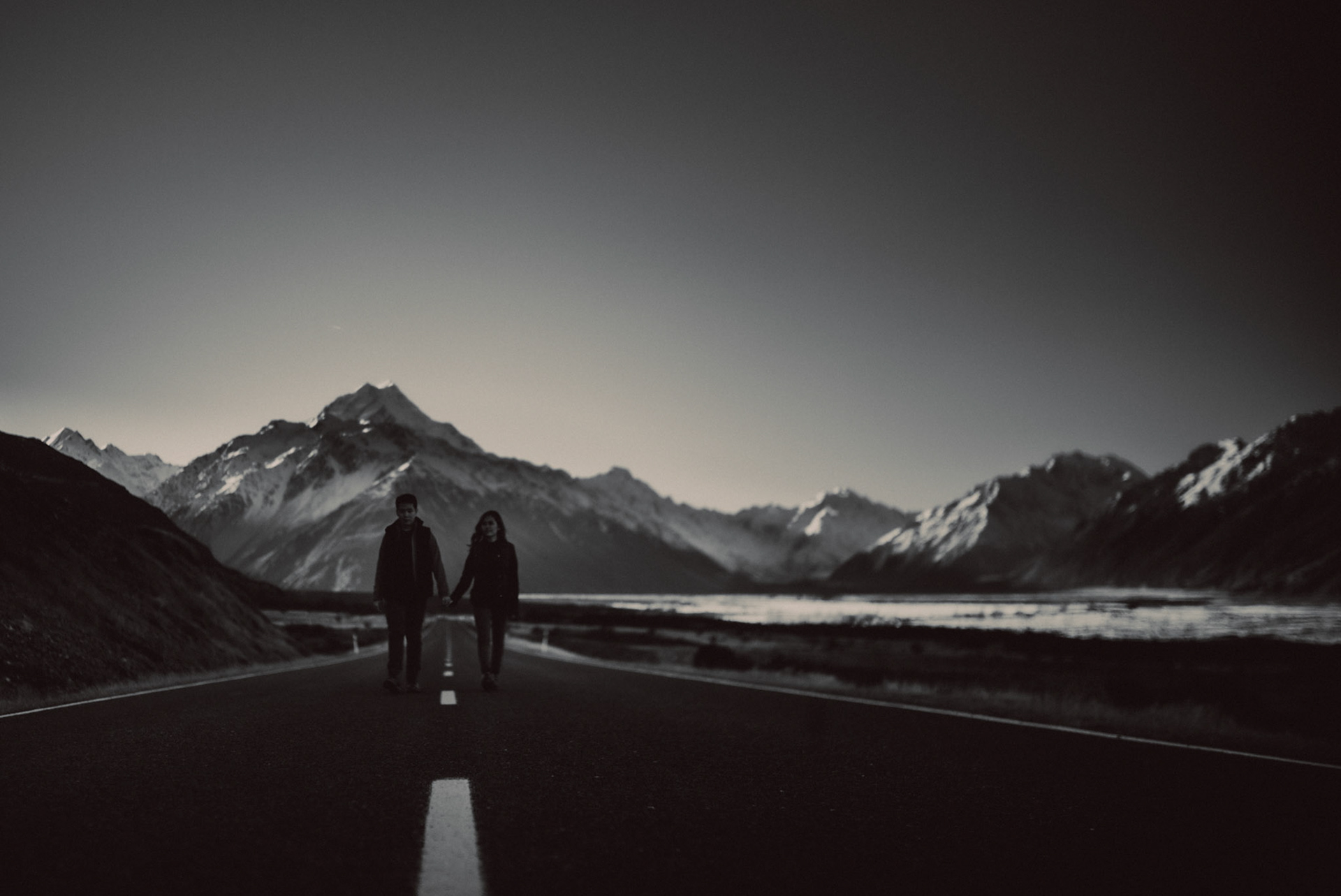 Moody pre-wedding portraits with Mount Cook's prominent snowy mountain peak and a lonely road, in black and white, New Zealand, June 2017, Leica M.