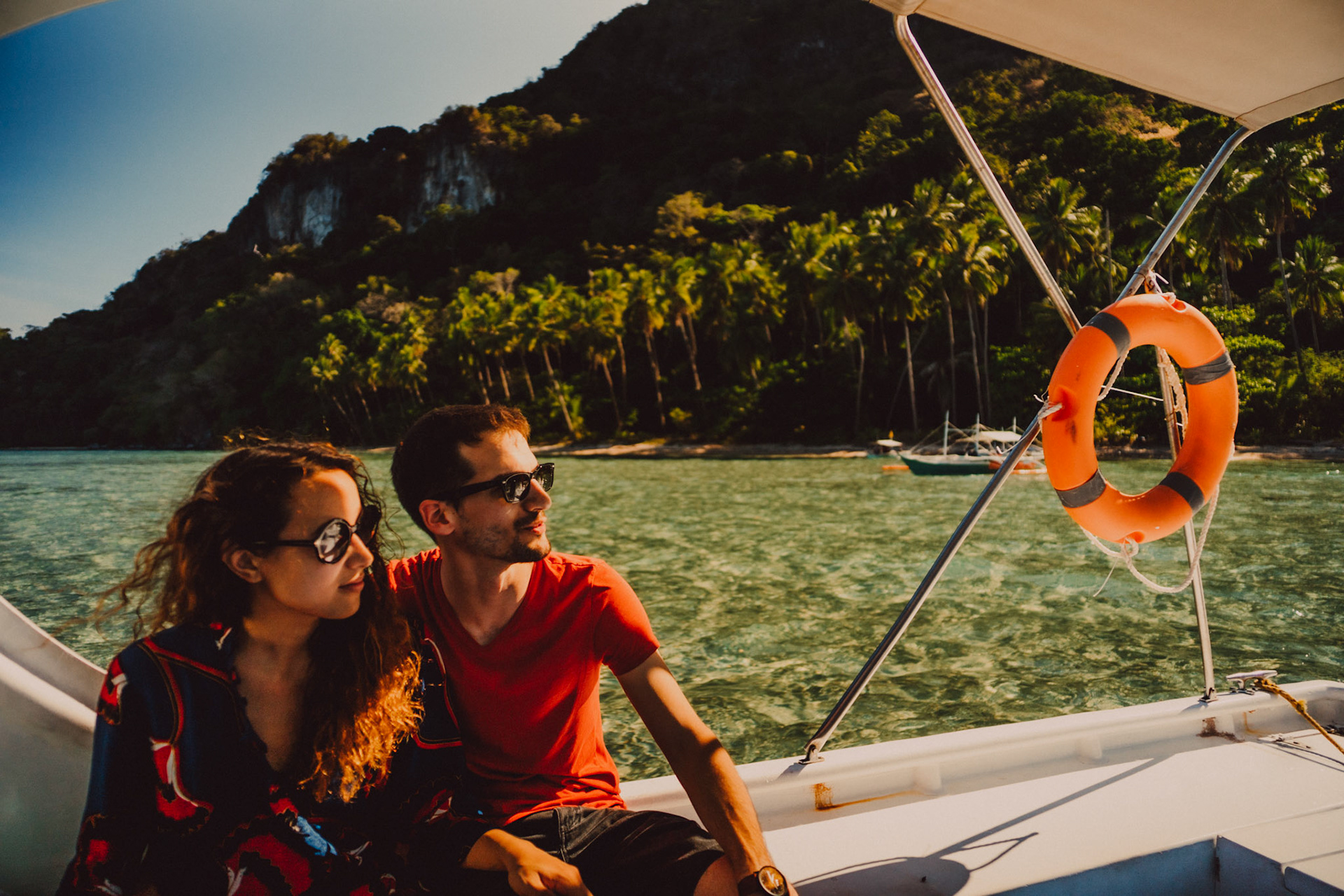Couple portraits on a speedboat approaching Bukal Beach's idyllic cove, Cadlao Island, El Nido, Palawan, Philippines, Southeast Asia, April 2019, Sony A7III.