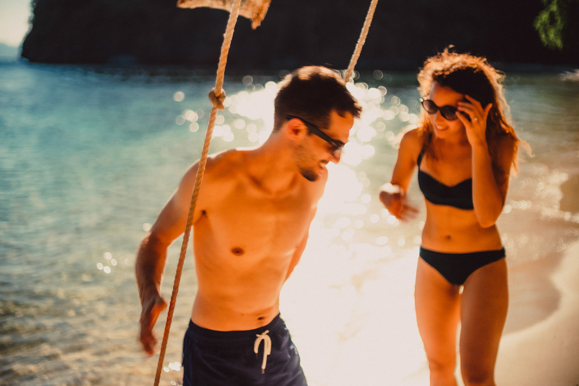 Candid and chill couple portraits by a swing in Paradise Beach, Cadlao Island, El Nido, Palawan, Philippines, Southeast Asia, April 2019, Sony A7III.