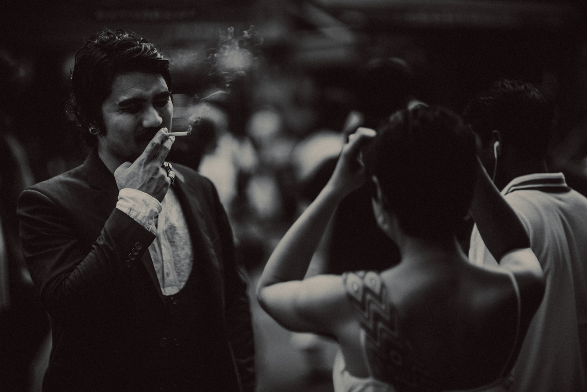 A candid, reportage-style engagement shoot in Little India on a Sunday afternoon feauring a Japanese couple, in black and white, Farrer Park, Singapore, October 2015, Sony A7S.