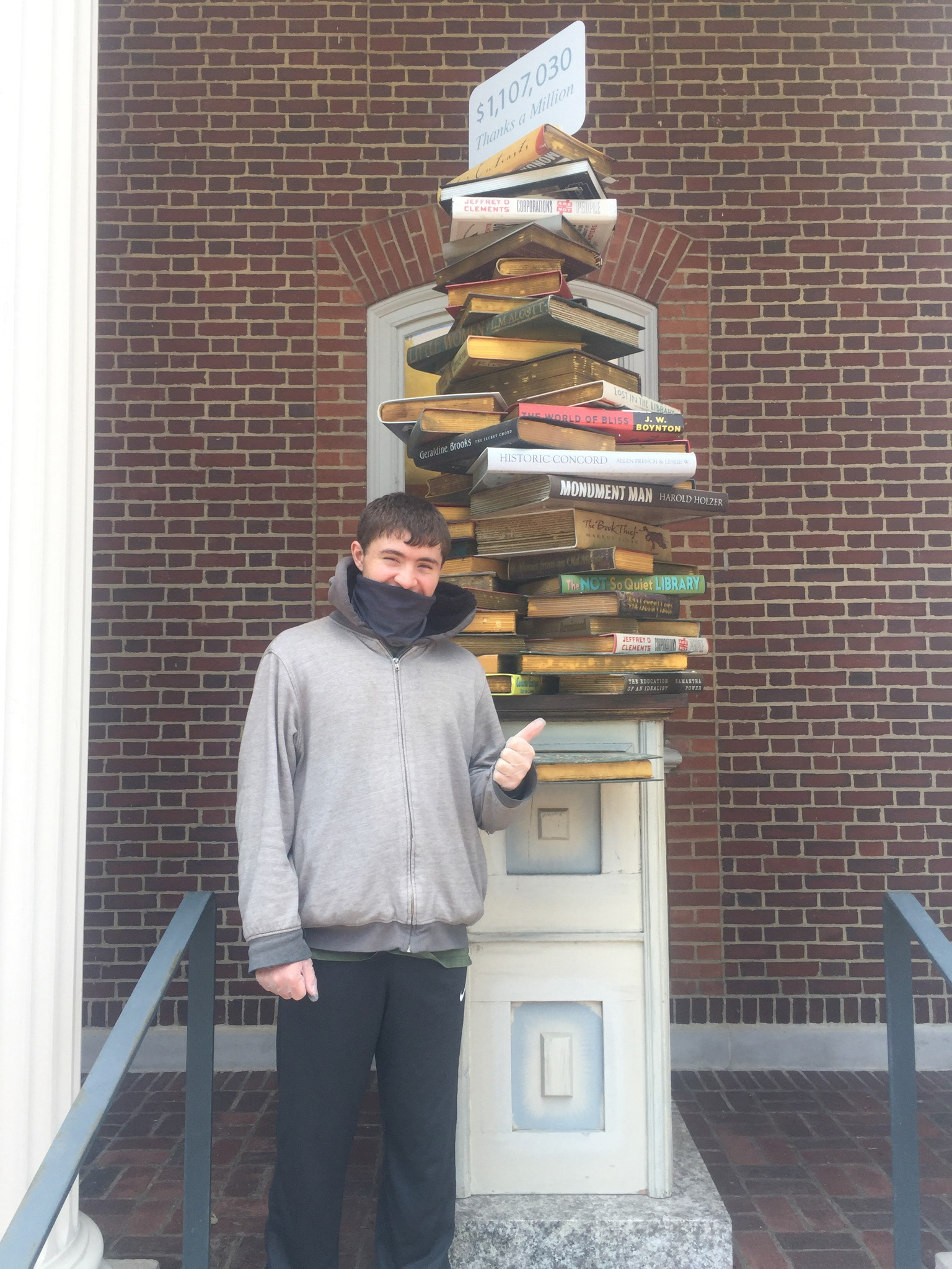 My cousin/Intern Brandon showing off the final book drop display with spinning sign at the top thanking all involved. The 1 million dollar goal was met.
