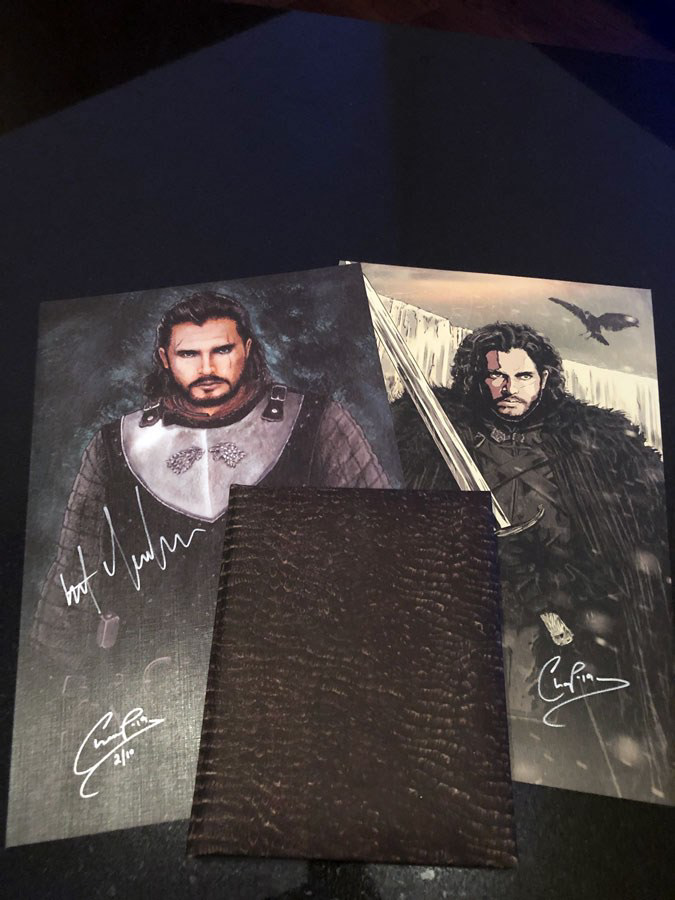 Book Cover with a print of the published art and newer King in the North art signed by actor Kit Harrington