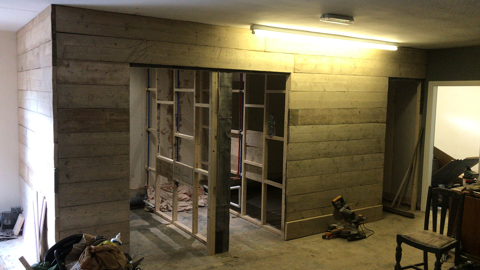 cladding the toilets with reclaimed scaffolding, a lot of sanding involved
