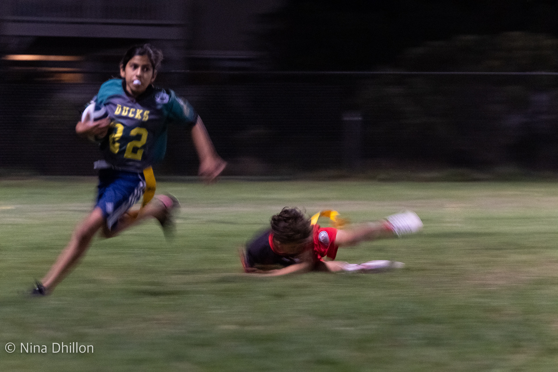 GIRLS are FAST. Nina evades the opposing team as she takes off for a touchdown! San Diego, CA. By NinaD.ISO 3200 f/8.0 1/30 sec 174.2mm