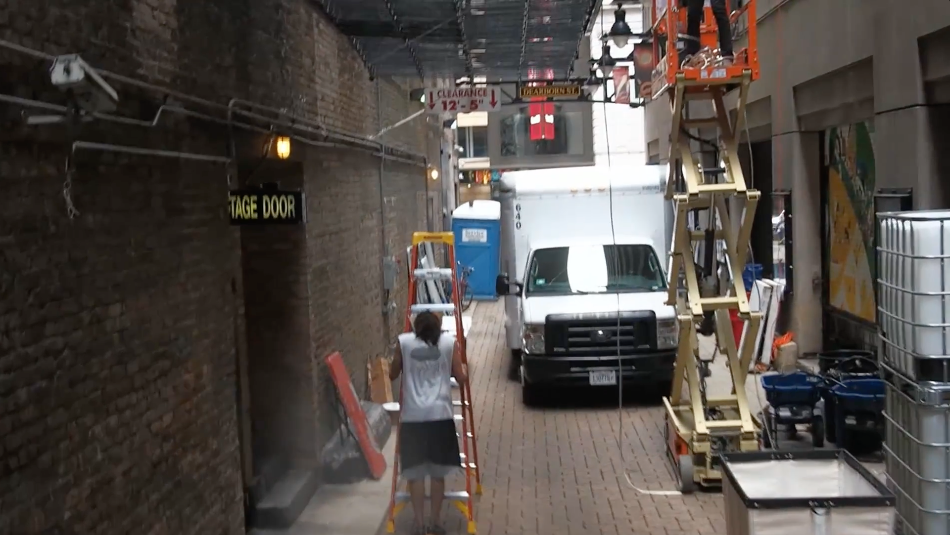 Christian prepares to install art in the alley.