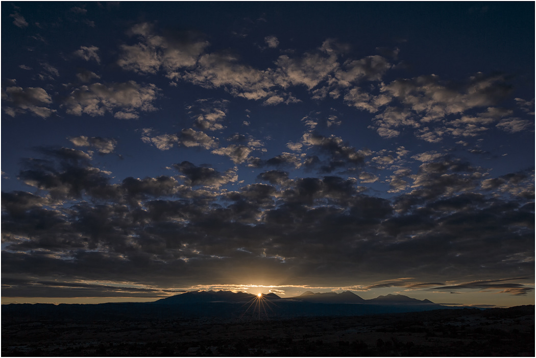 Sun rising above La Sal Mountains - Arches NP, Utah