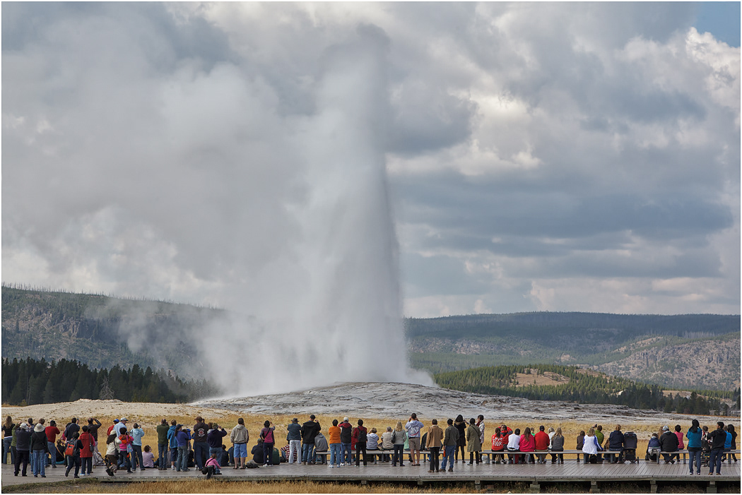 Tourists viewing an eruption of Old Faithfull,  Yellowstone NP