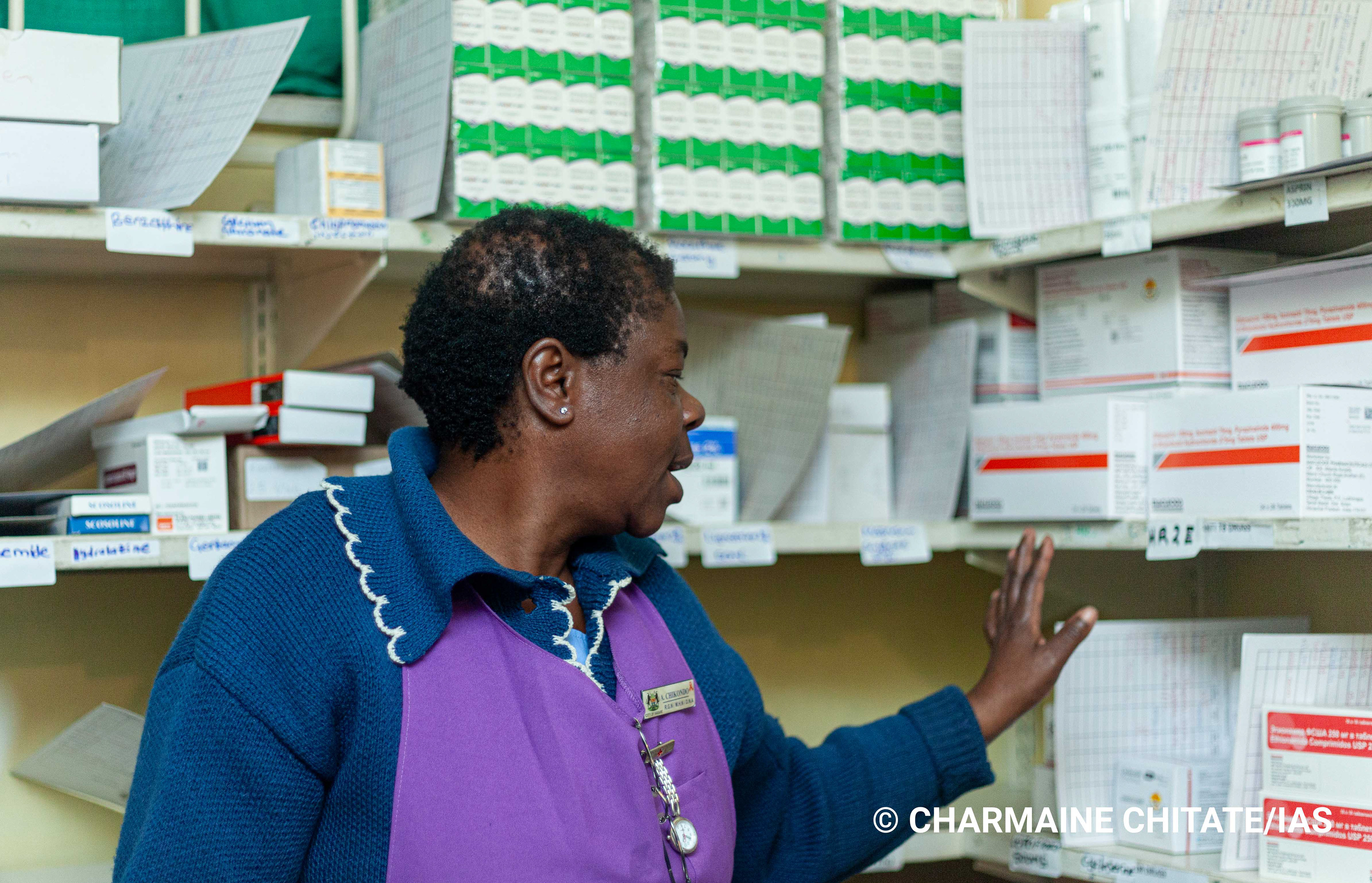 Sr. Angela Chikondo assesses TB medication in the storeroom at Rutsanana Polyclinic. (Photographer: Charmaine Chitate/IAS)