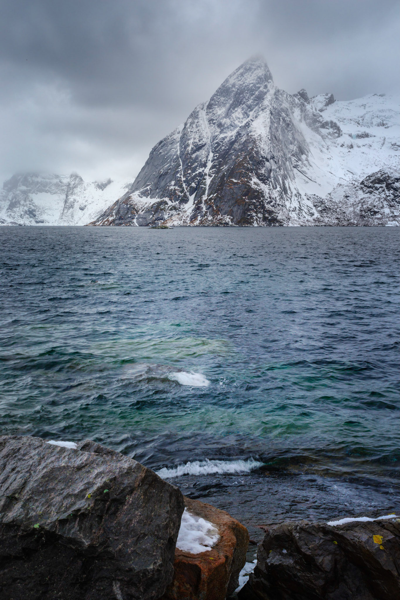 On a day where the clouds were rolling in and out very quickly, the views of the peaks across the bay were very fleeting.Hamnøy, Nordland, NorwayMarch 17, 2018PENTAX K-1, HD PENTAX-D FA 24-70mm F2.8ED SDM WRISO 400 36 mm  ¹⁄₂₅ sec at ƒ / 11