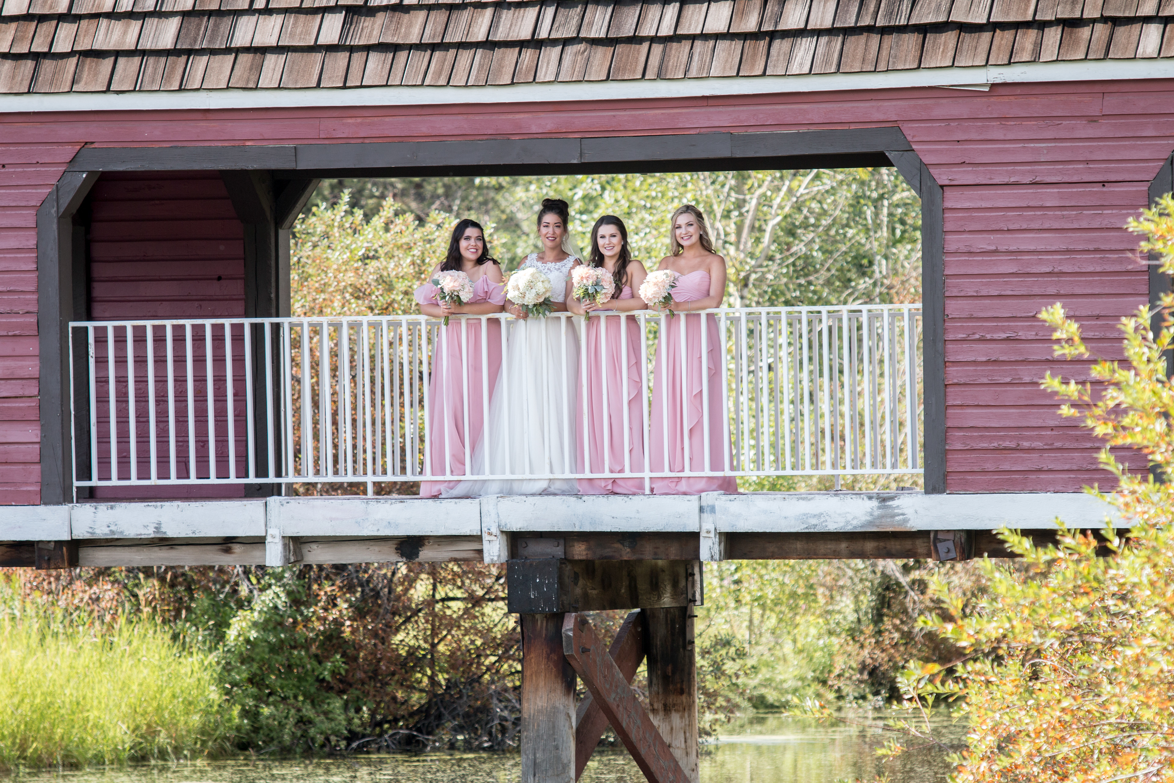 bridesmaids on a bridge in the summer in Edmonton
