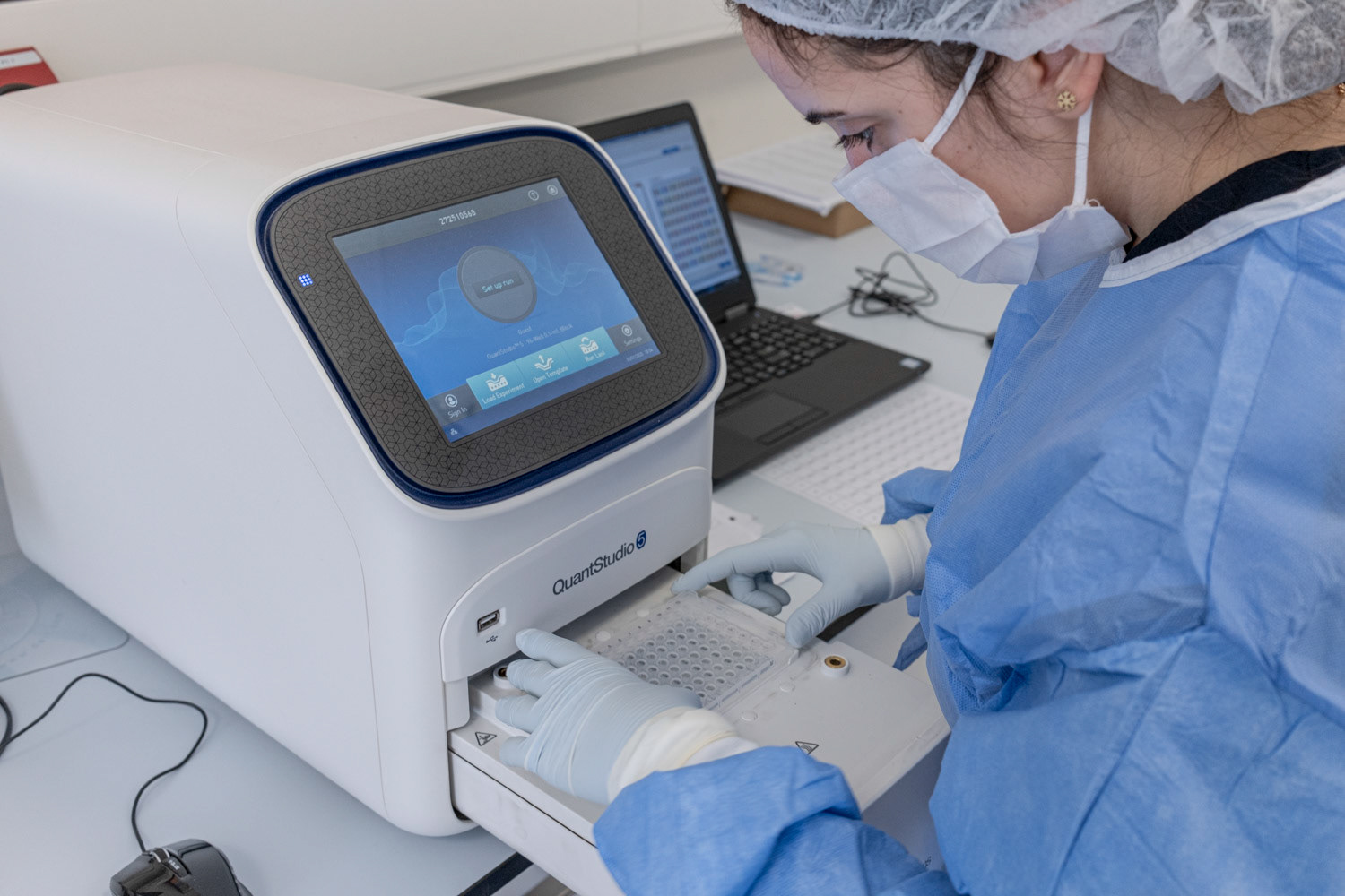 A molecular biologist wearing protective equipments as she loads the patient samples to thermal cycler at a private laboratory of hospital in Istanbul on 1 May 2020.