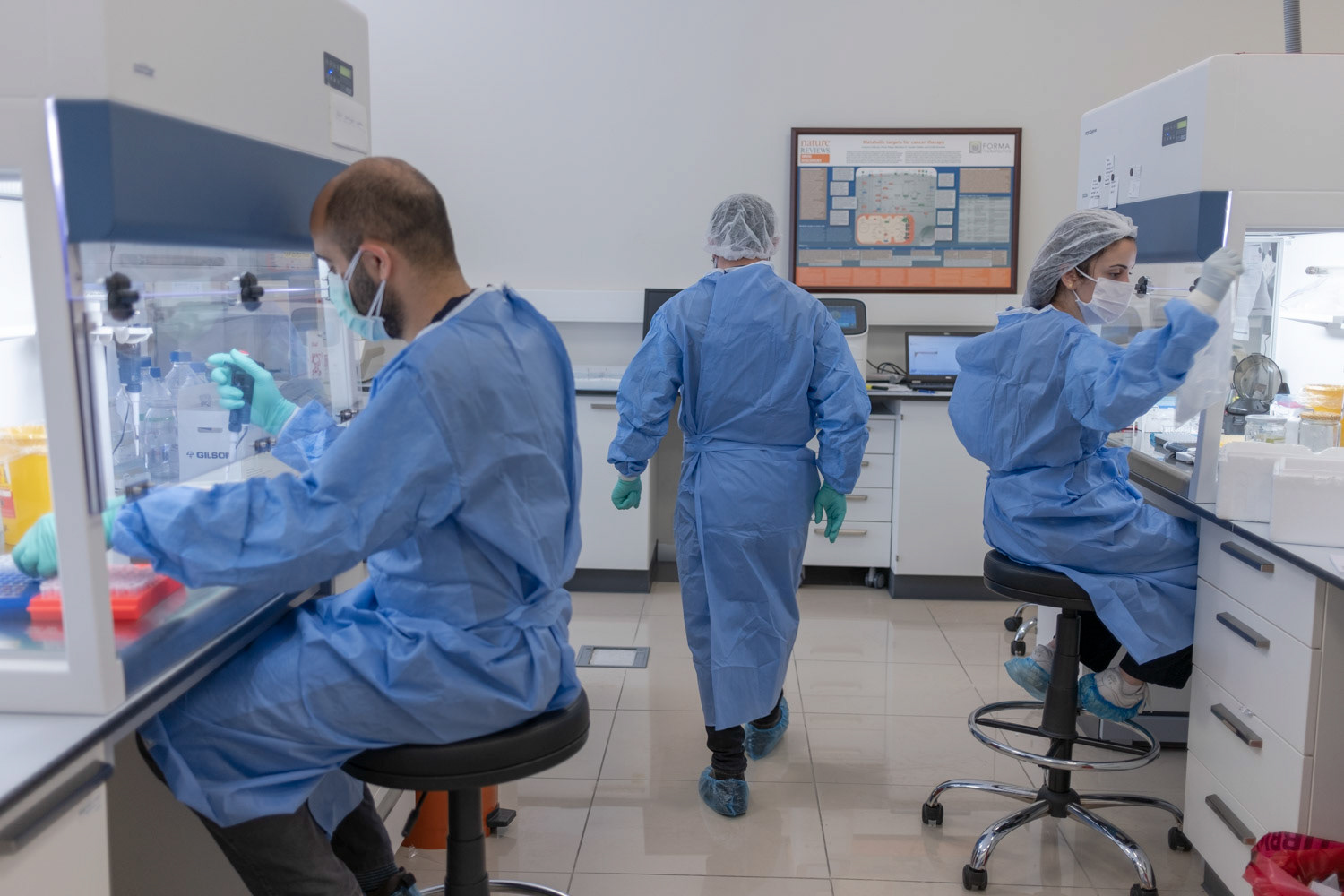 Molecular biologists wearing protective equipments as they prepare samples for analysis at a private laboratory of hospital in Istanbul on 1 May 2020.