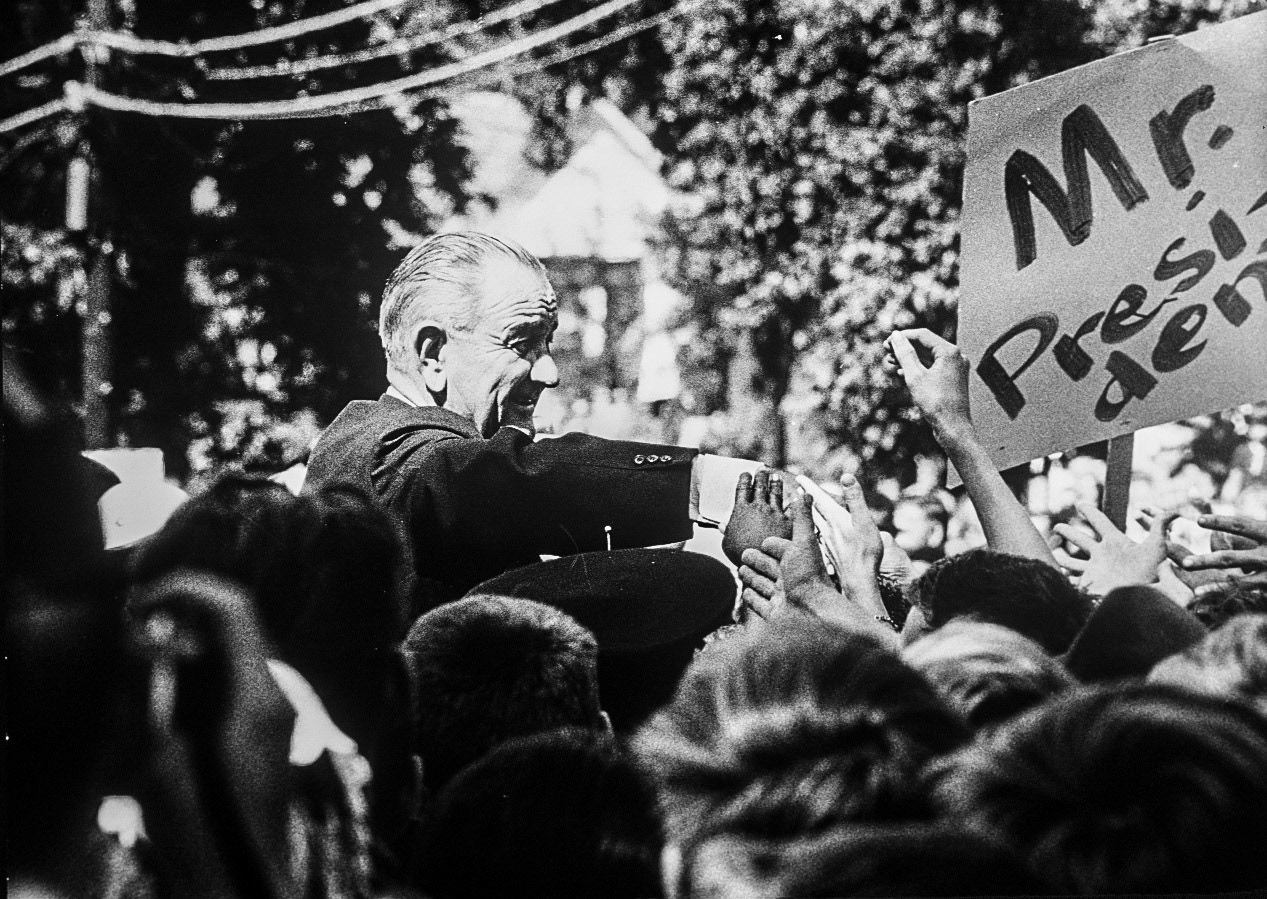The President greets crowds during a motorcade stop in Battle Creek, Michigan, September 9, 1966.