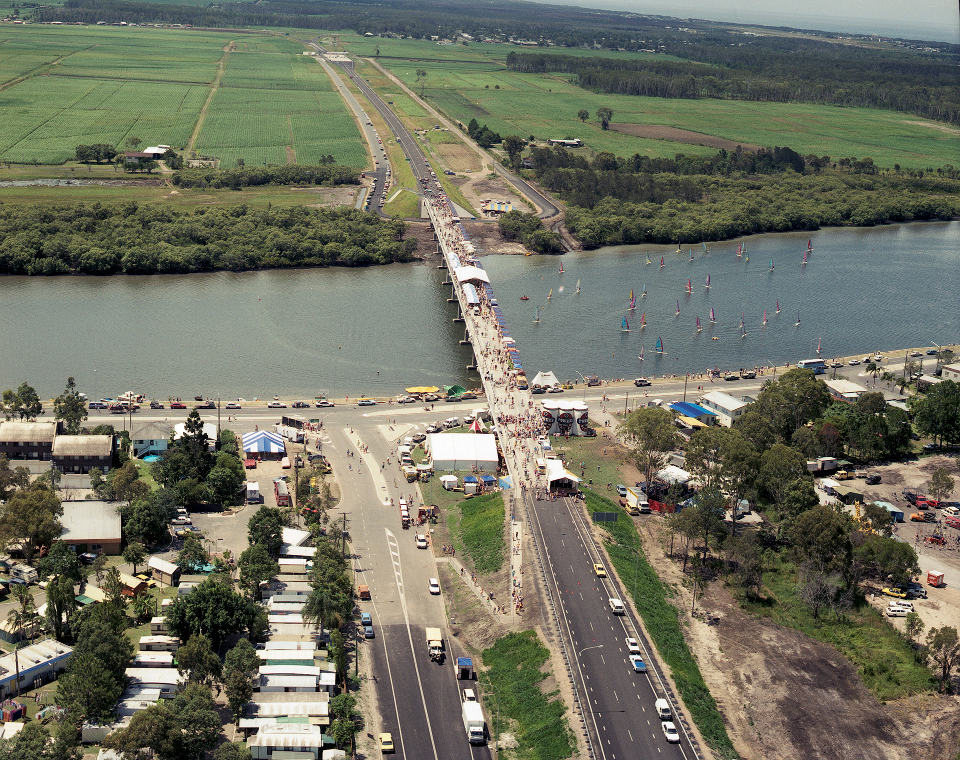Official opening of Sunshine Motorway (stage 1) at Maroochy River Bridge. Present at the opening ceremony were The Hon David Hamill, MLA, Minister for Transport, and Geoff Fraser, Chairman of Directors, Sunshine Motorway Company., Aerial photograph of the official opening of the Sunshine Motorway (stage 1). Maroochy River Bridge open to pedestrian traffic