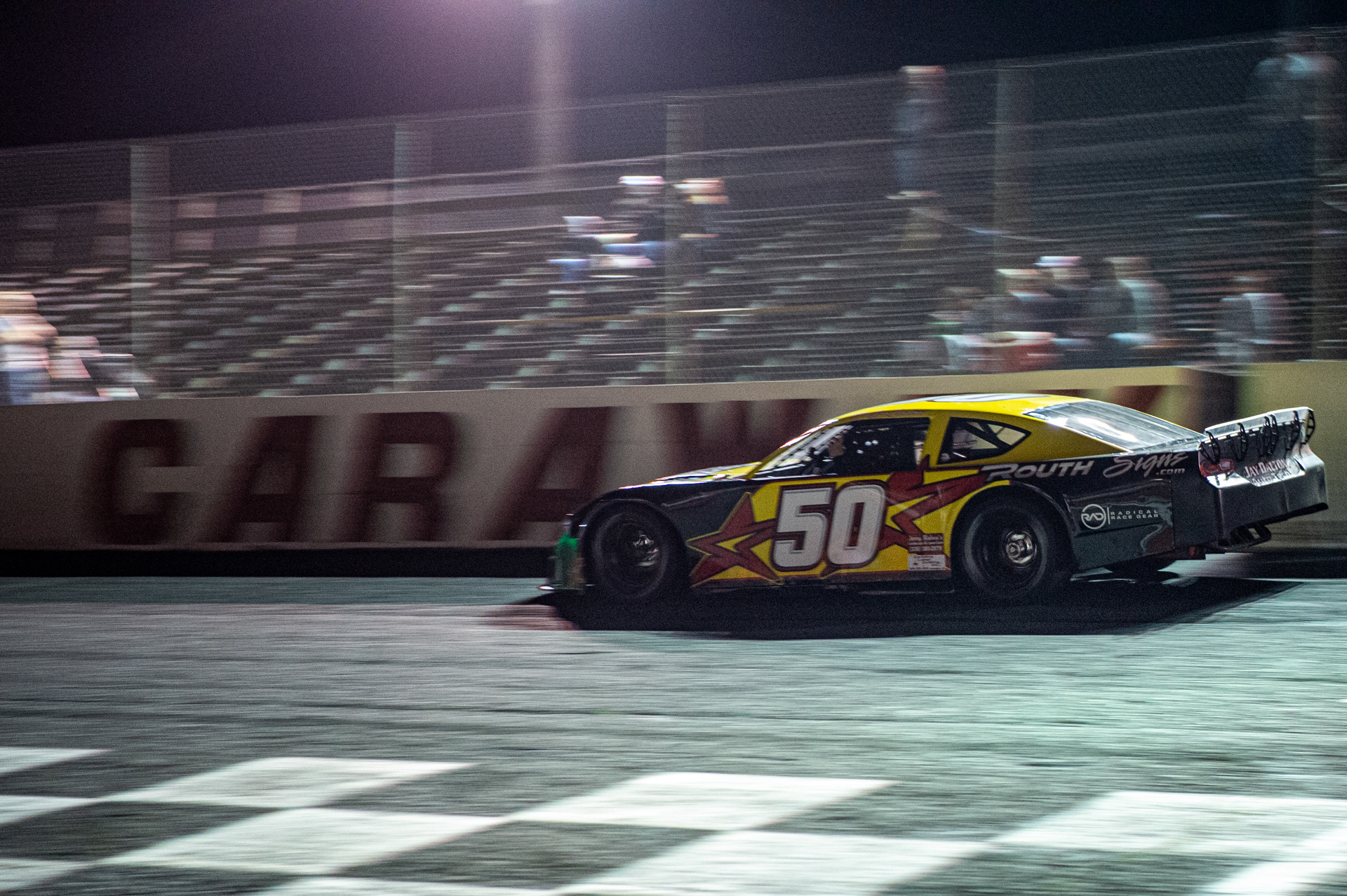Ross "Boo Boo" Dalton crosses the finish line at Caraway Speedway's Twin Night at the Races in Sophia, N.C. on March 27, 2021.