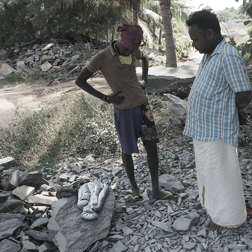 Master stone sculptors look on
