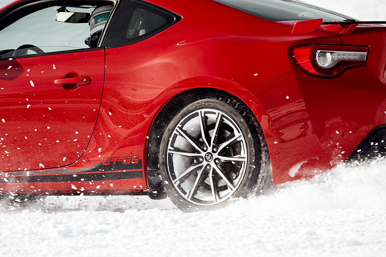 Photograph of red Toyota racing on ice track