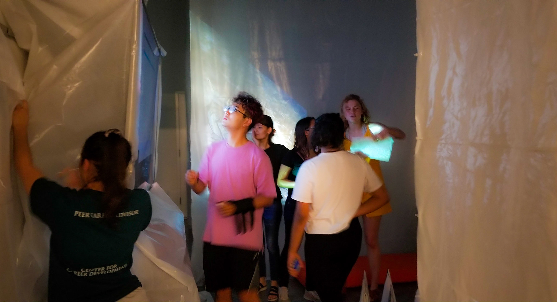 Students working on finishing touches on the installation.