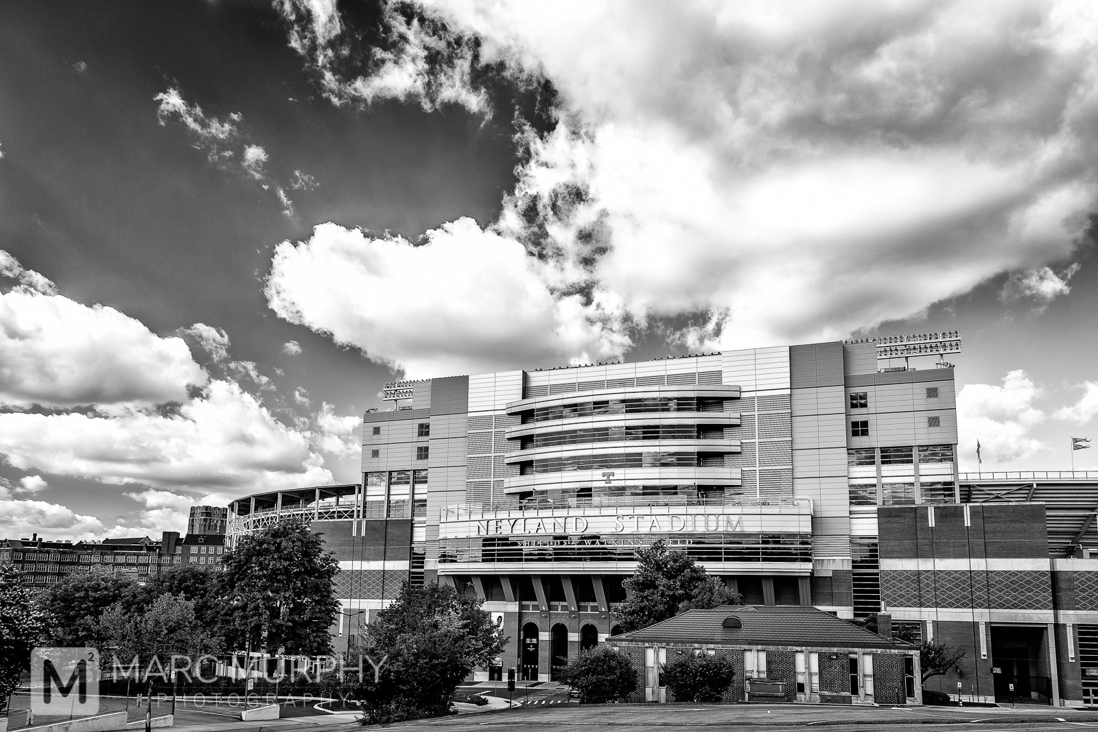 Black and White University of Tennessee Knoxville Football Stadium Exterior with Big Fluffy White Clouds in Sky