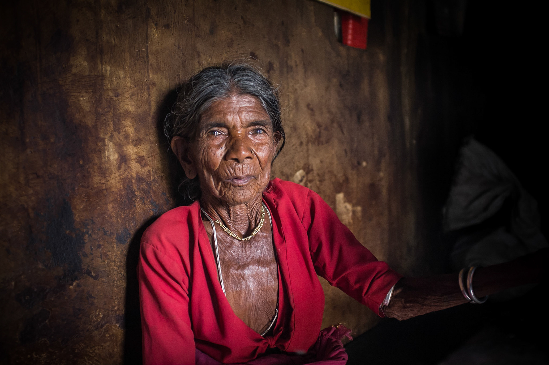 Gorita, Andhra Pradesh, India. A woman avoids the summer sun be taking refuge in a village house. Taken September 5, 2012.