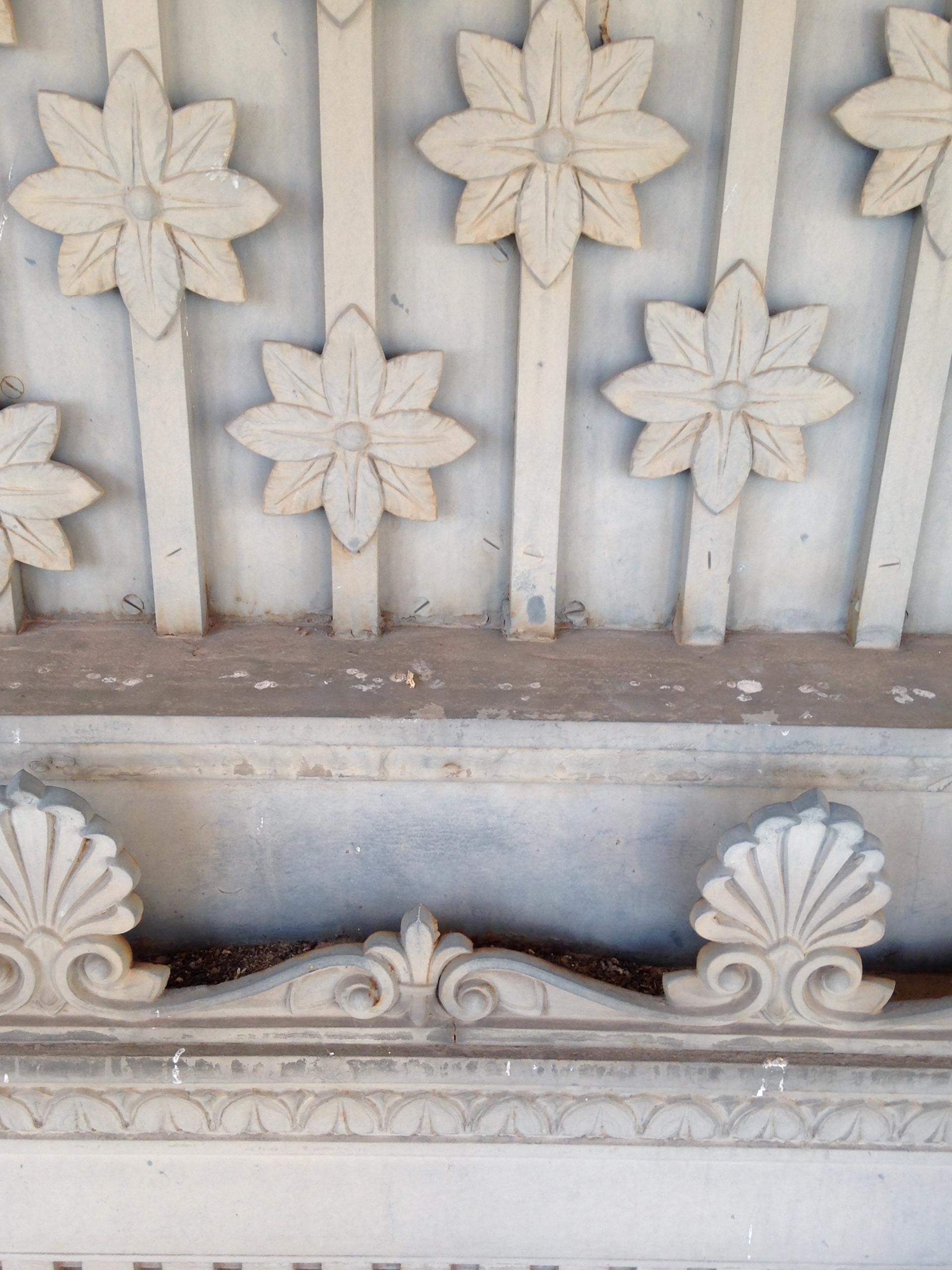 Floral detailing above the doors presented multiple layers and attachment methods.