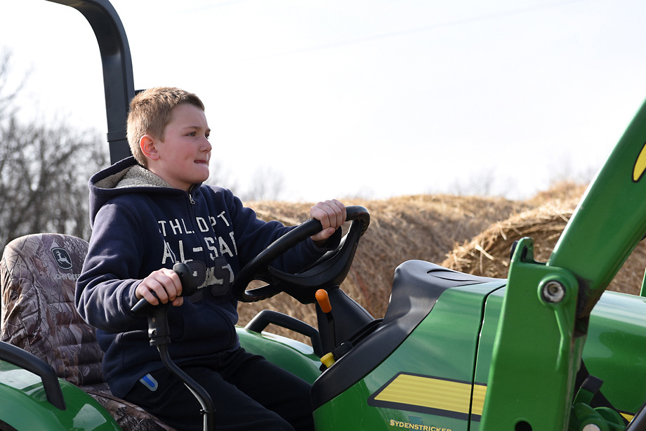 Tate Wehrle, 10, drives a tractor to move hay bales Sunday, December 8, 2019 in Rhineland, Missouri. Tate learned how to drive the tractor when he was eight years old and maneuvers the hay bales with confidence and ease.