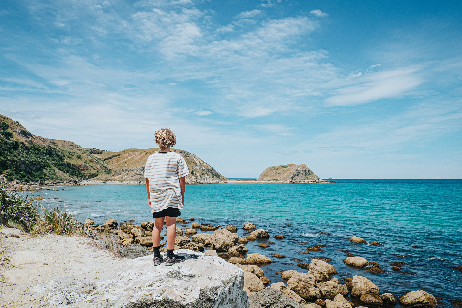 Boy looking out to the view from Tongoio beach in Hawke's Bay