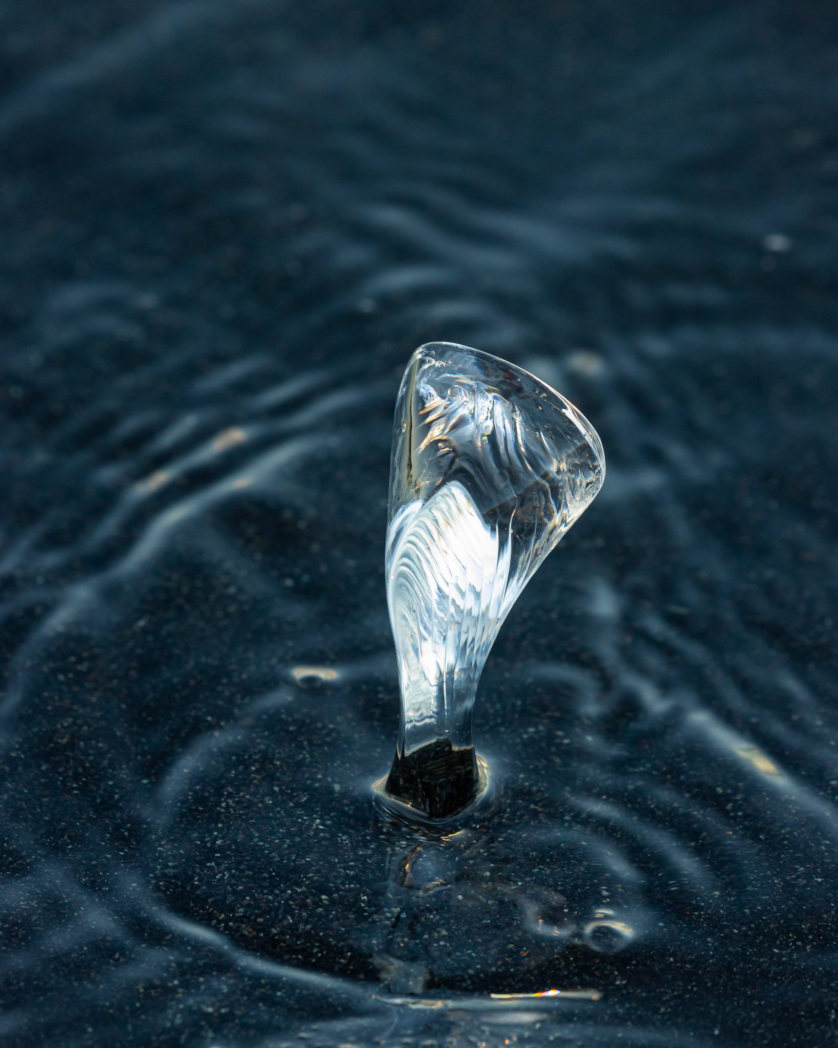 Ice Glow - light refracting through ice on the black sand at Jökulsárlón Glacier Lagoon, Iceland