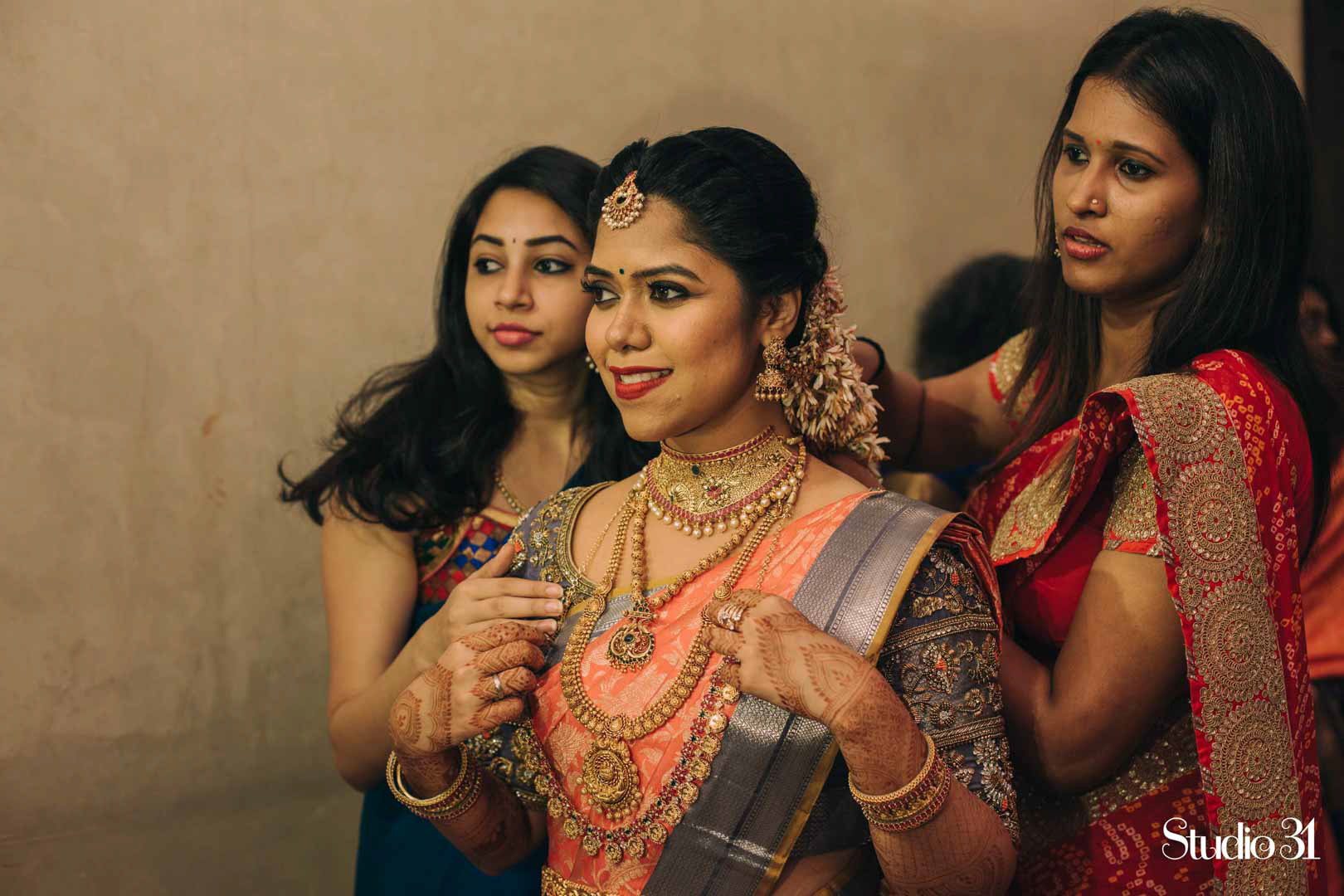Getting ready shot of a bride by Studio 31 at Sree varaaham hall,Chennai