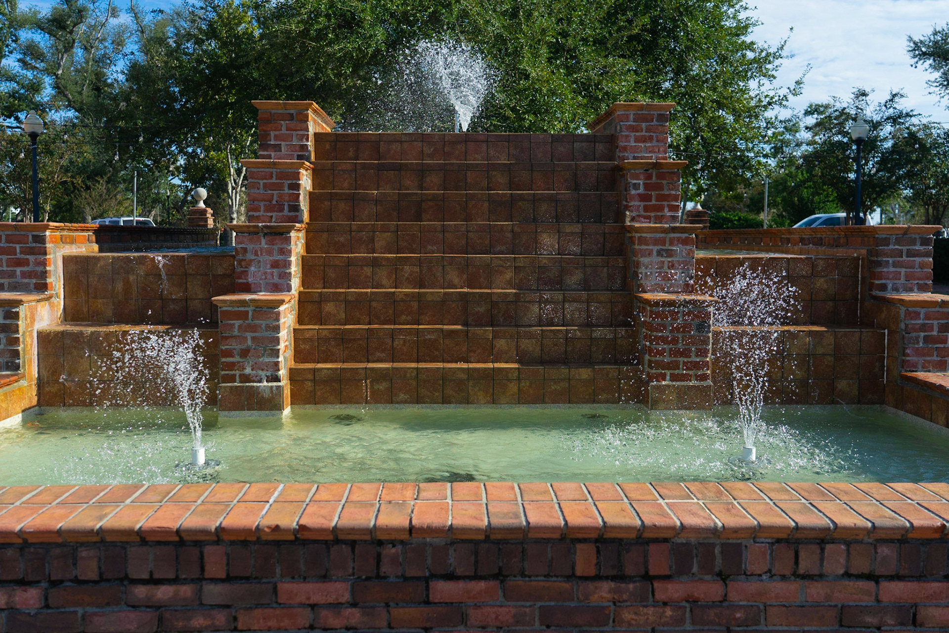Symmetry and Reflection: City park fountain, capturing the symmetry of the structure, 20201029, Historic Panama City, MILLER, I found this fountain with the idea to line it up for a Symmetry and Reflection composition. In retrospect I wish I would of moved my frame over slightly to the left to truly capture a symmetric image, but through out the shot what you see one one side you can see on the other side down to the detail of the tops of the parked trucks in the background Camera Settings: Sony A7 II, ISO 200, 34mm, f5, 1/2000s