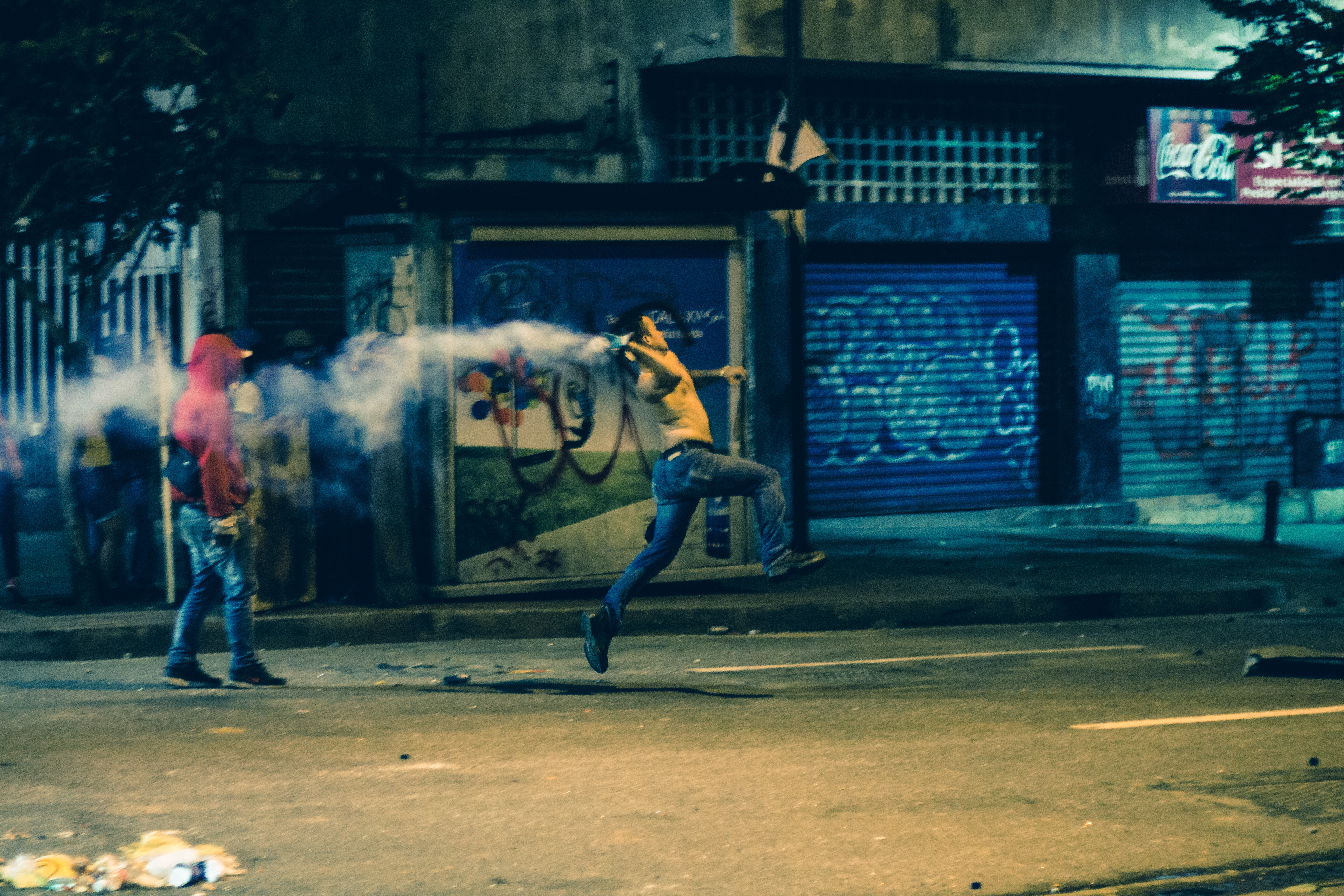 A protester throwing a Molotov cocktail to the police. Caracas 2014