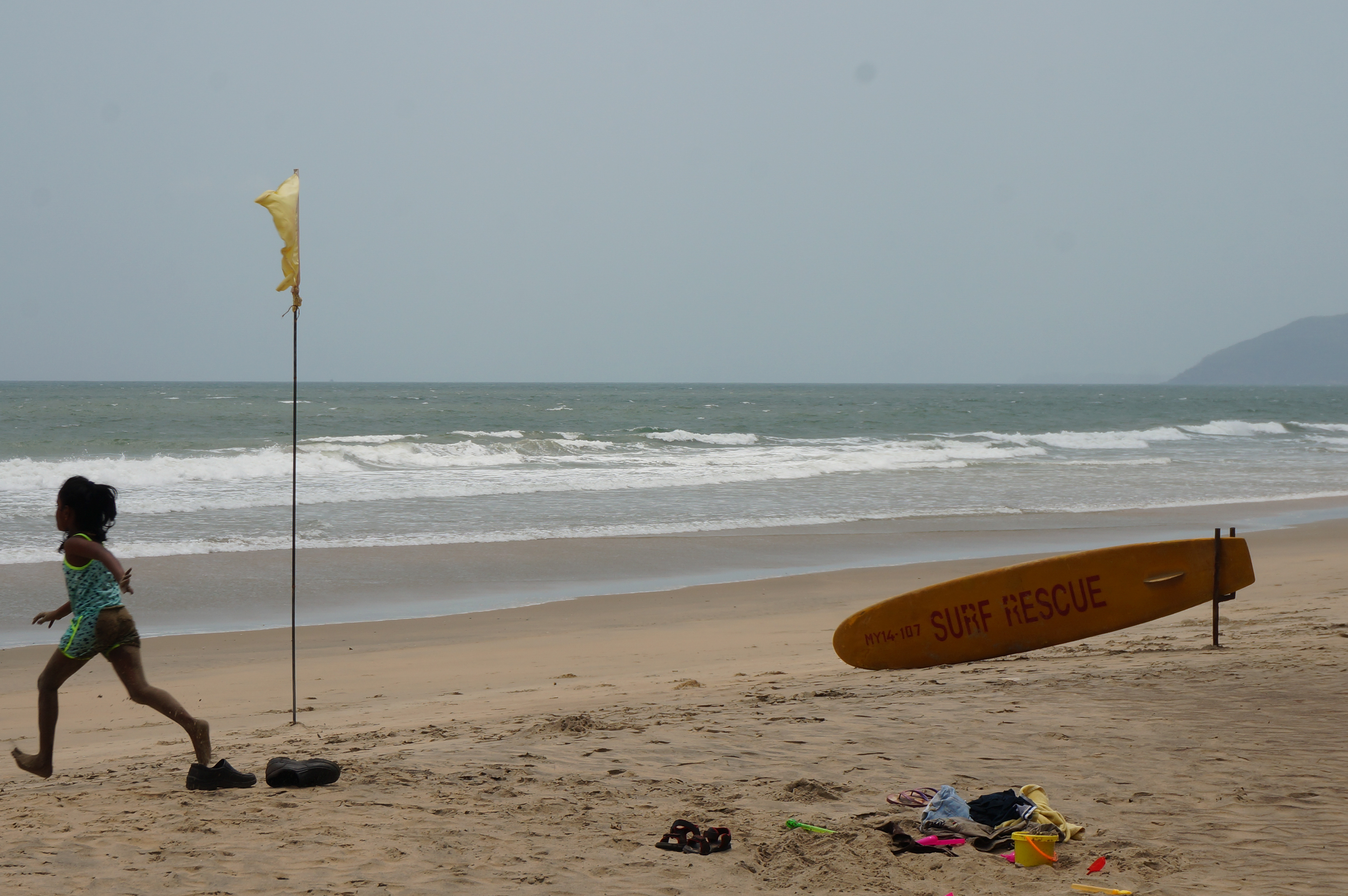 Child running on a beach in Goa, India, April 2018