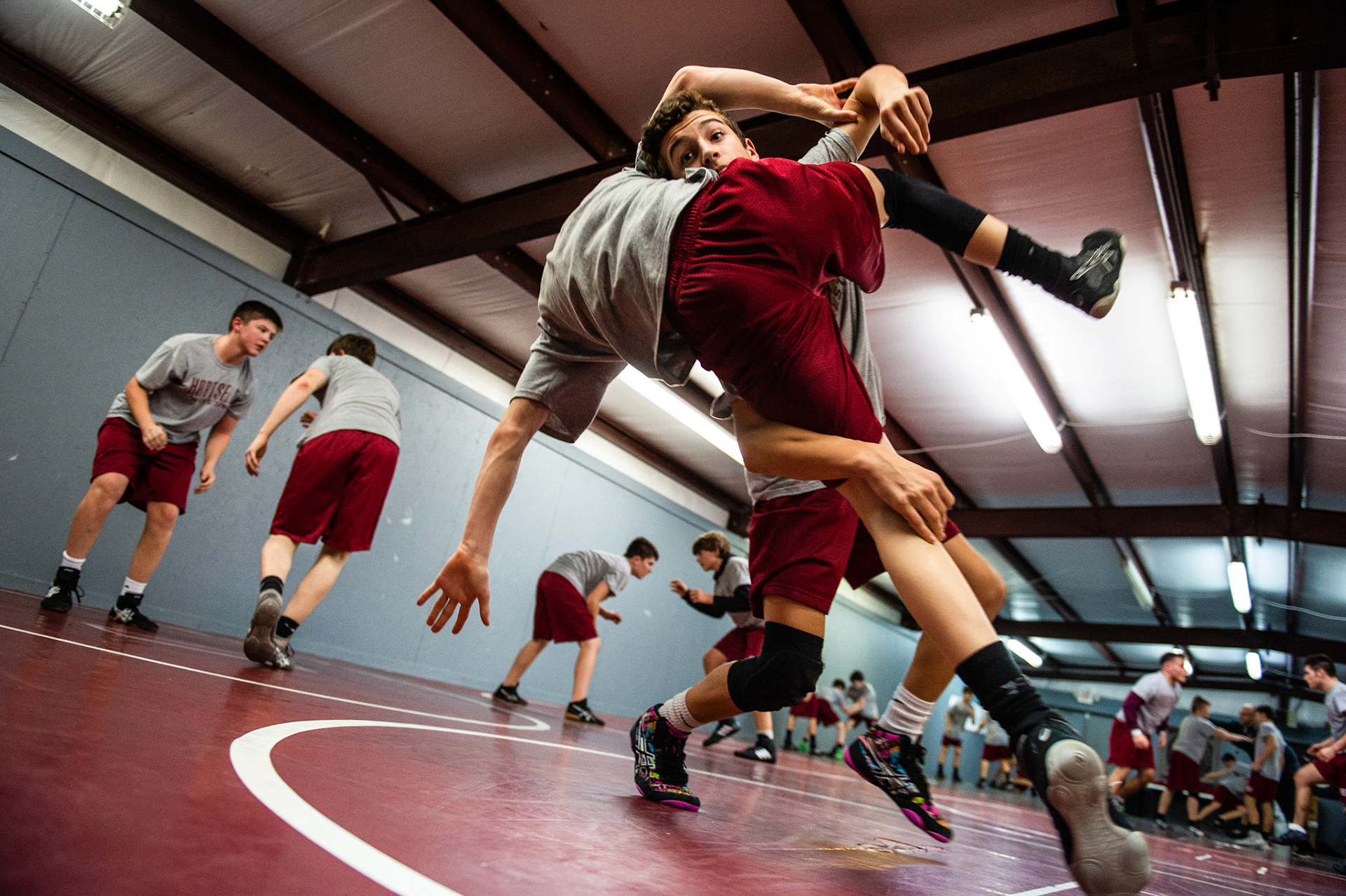 Student Payton Roberts, top, tackles teammate Ethan England for an exercise drill during Hartselle Junior High's wrestling practice, Wednesday, December 19, 2018, at Hartselle Junior High in Hartselle, Ala.