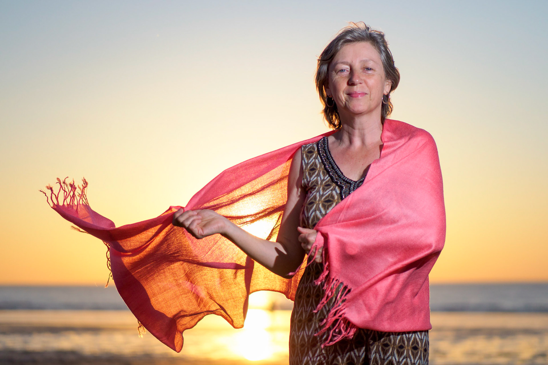 Adult female with pink scarf on the beach V