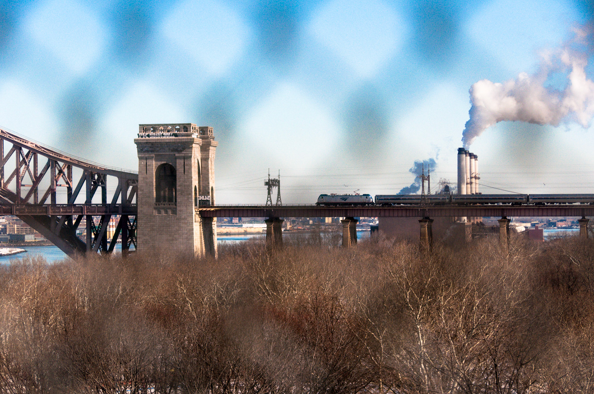 Amtrak train crosses the Hell Gate Bridge from Queens to the Bronx.