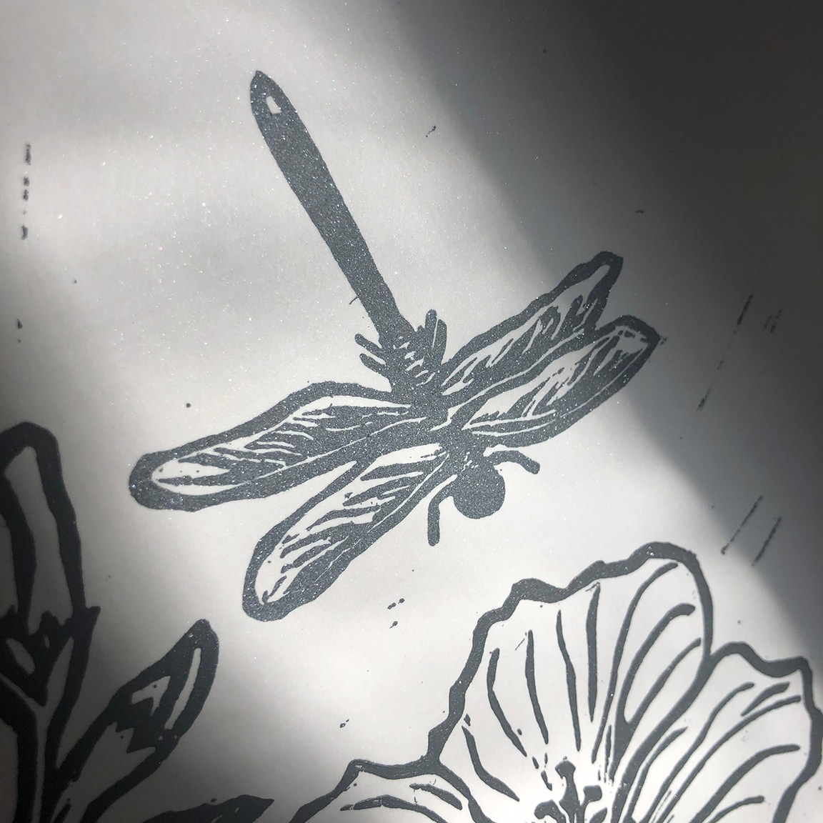 Detail of linoleum print, I finished this with iridescent mica powder on the dragonfly.